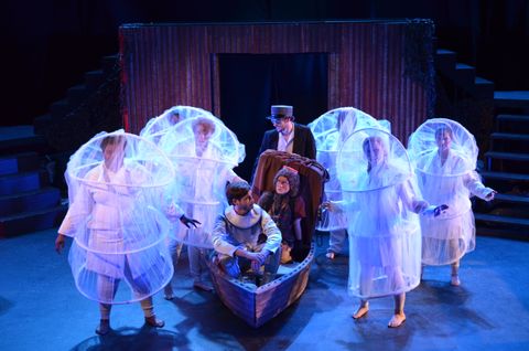 Dionysus travels in Charon's boat to the underworld. They encounter the neophytes. They are lit with blue down light, teal back light, and lavender side light.